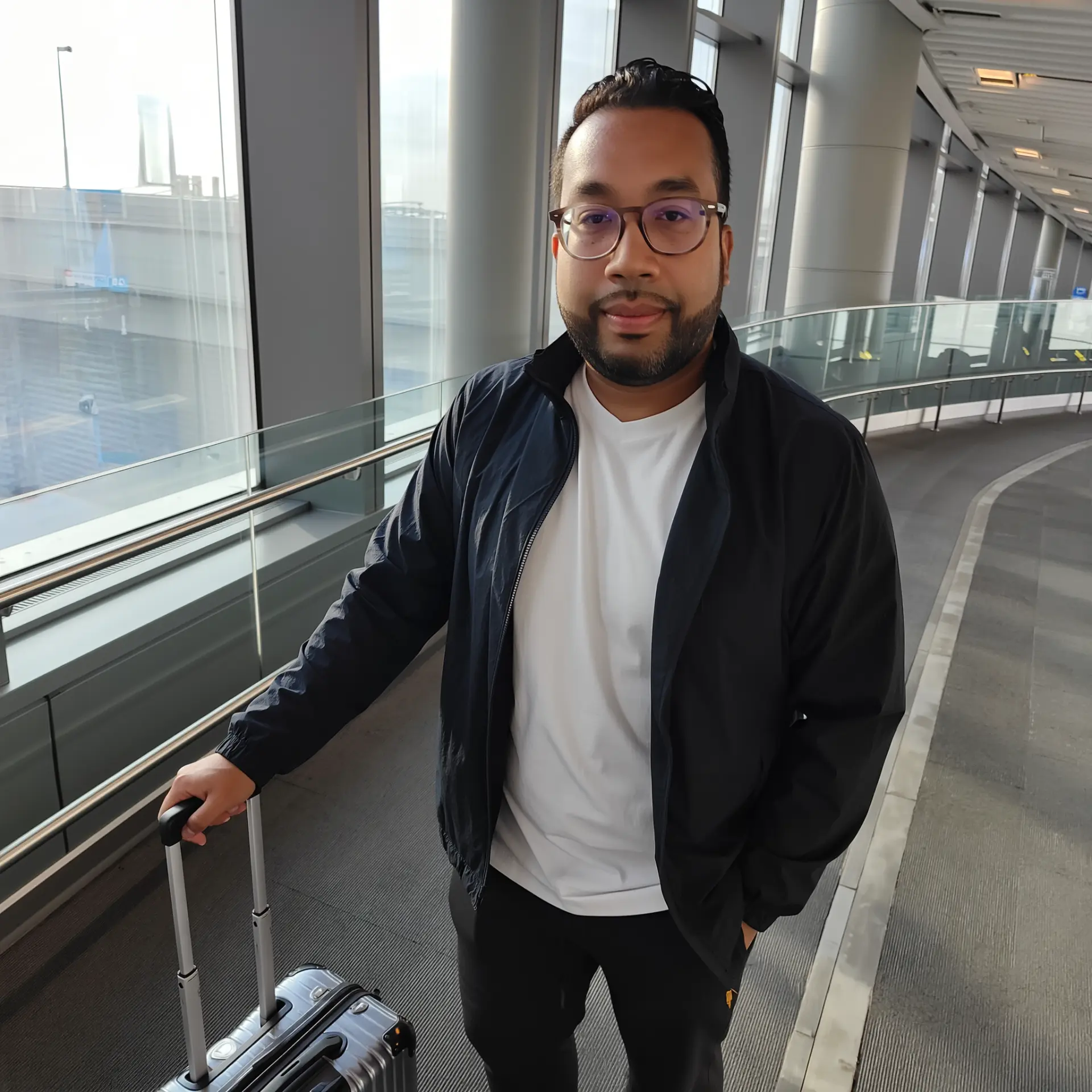Dr. D travelling with a suitcase at the airport
