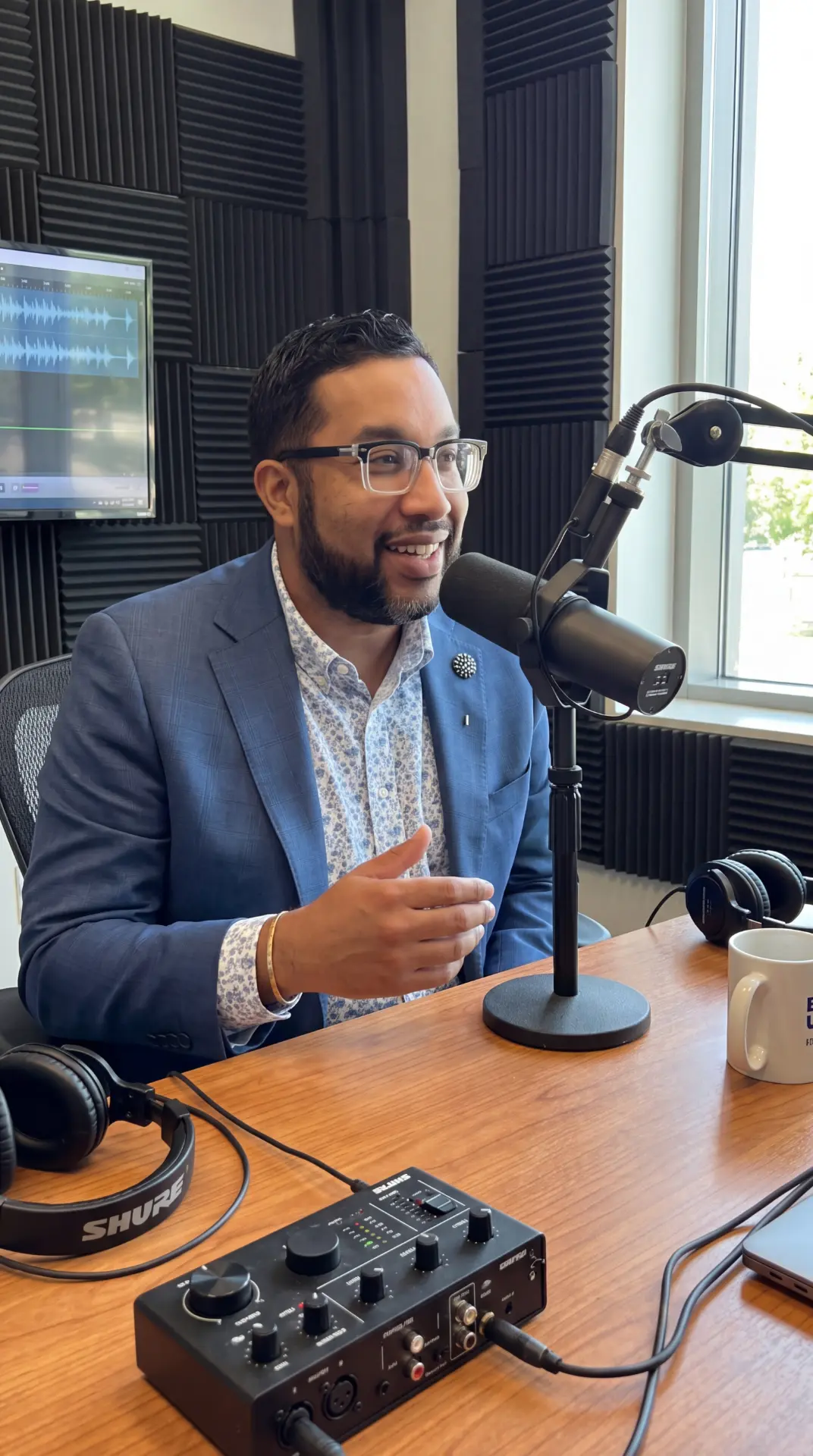 Dr. D recording in a podcast studio